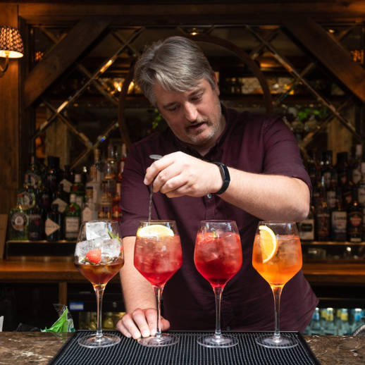 Man pouring drinks in bar on Northumberland's Golf Coast